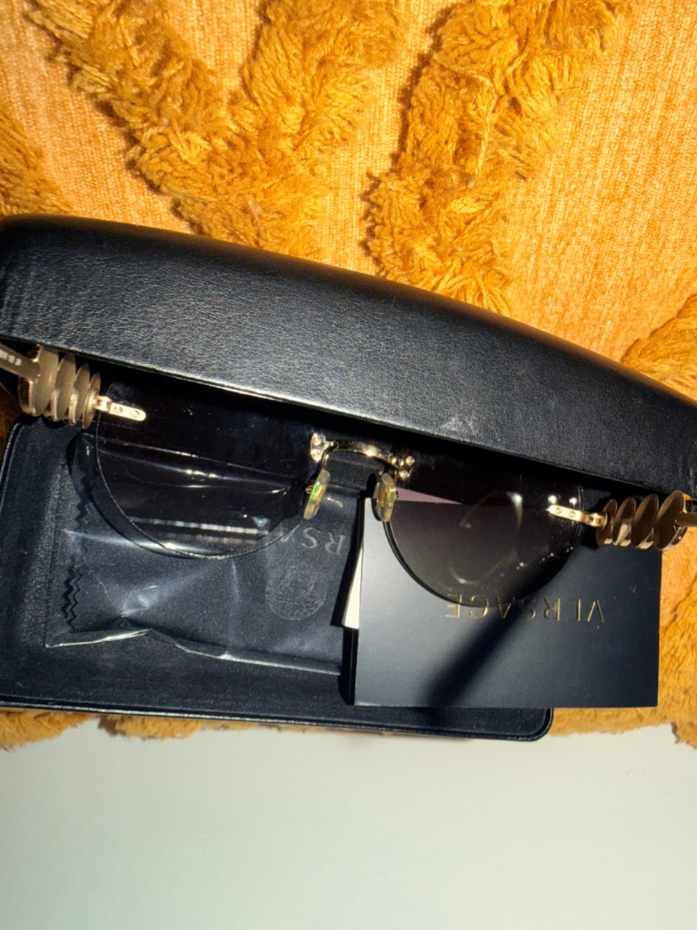 Versace Men's Black and Gold Rimless Sunglasses with Signature Medusa Temples